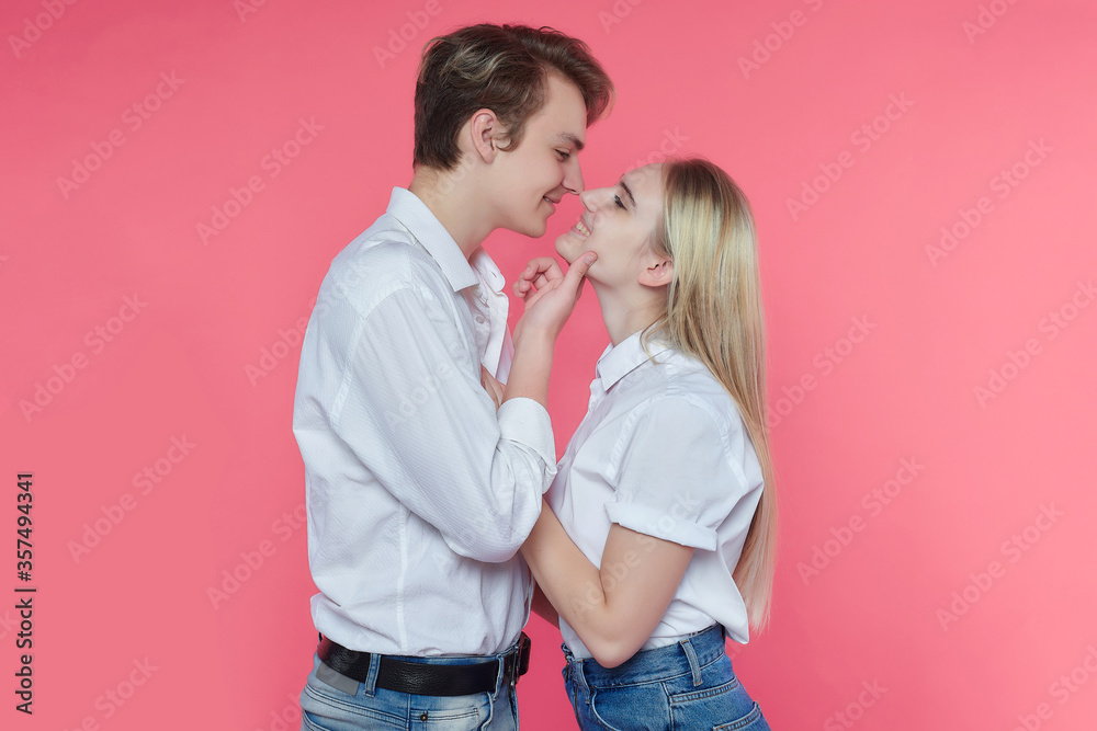 guy and girl in the Studio. expression of emotions and love. pink background guy and girl in the Studio. expression of emotions and love. pink background