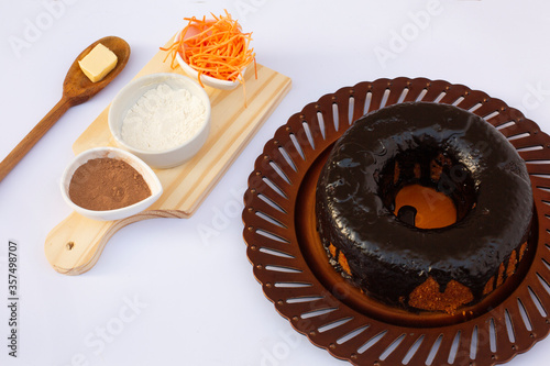 carrot cake with chocolate icing, healthy cake with 70% cocoa, white background.