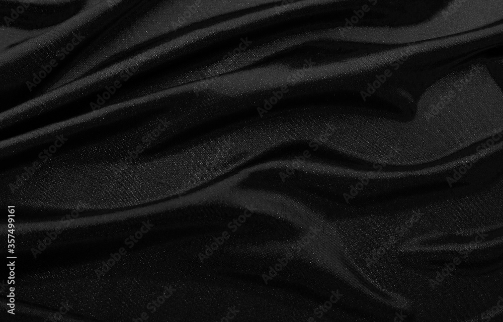 Obraz premium Texture of black fabric in waves.