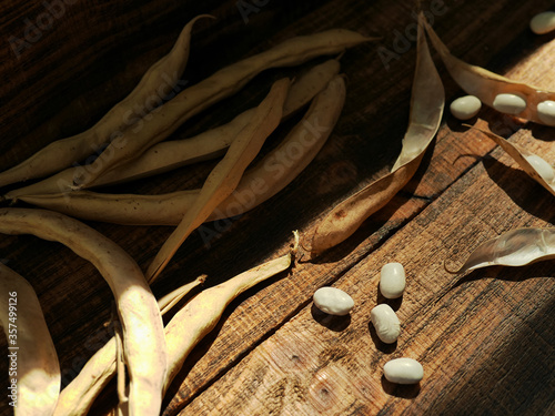 white kidney beans on wooden background. Dried organic harvest of white beans photo