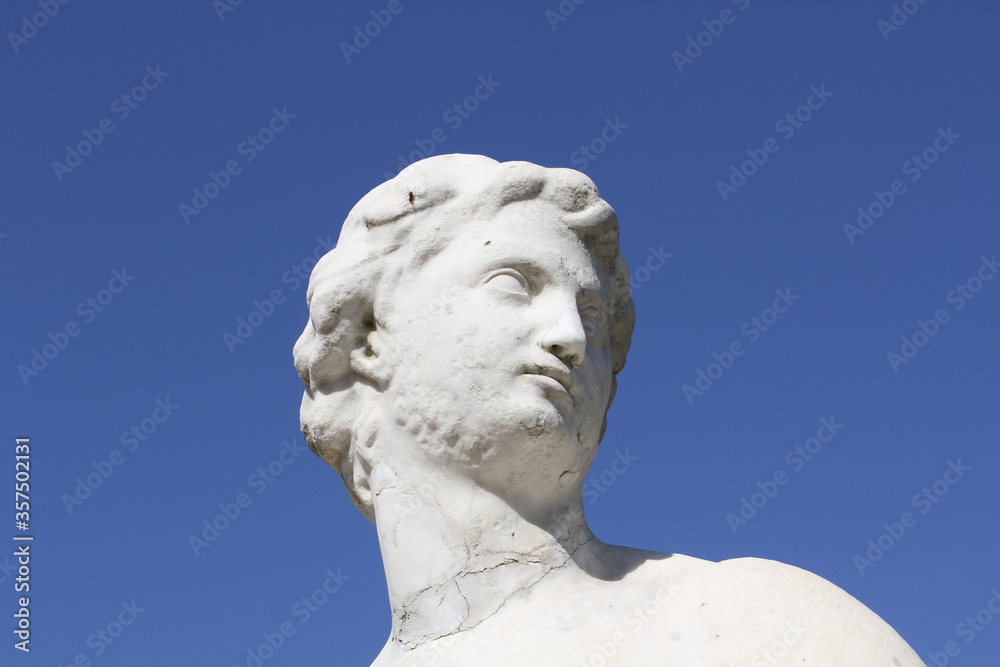 antique statue against a blue sky