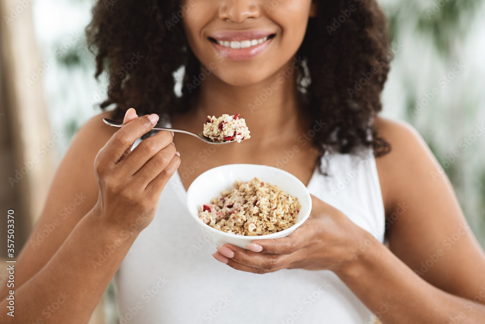 Healthy Nutrition. Unrecognizable Black Woman Enjoying Oatmeals With Fruits, Cropped Image Healthy Nutrition. Unrecognizable Black Woman Enjoying Oatmeals With Fruits, Cropped Image