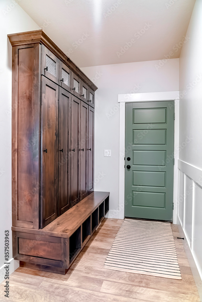 Fototapeta premium Hinged panelled wooden fire door with black knob and lock inside a home
