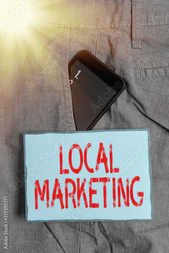 Handwriting text writing Local Marketing. Conceptual photo targeting audience located in a finelygrained community Smartphone device inside formal work trousers front pocket near note paper photo