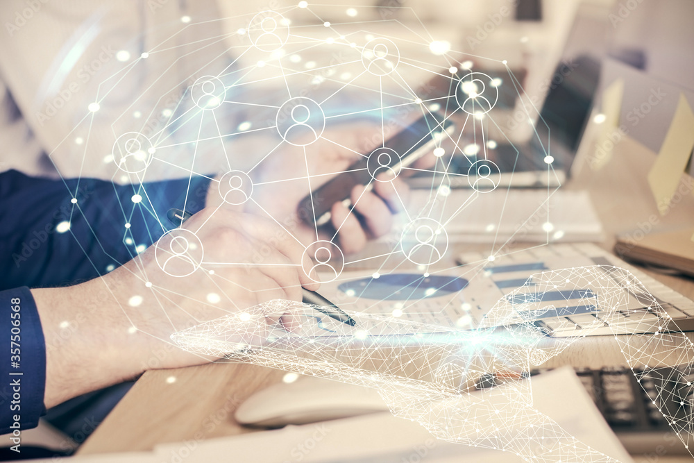 Double exposure of man's hands holding and using a phone and social network theme drawing. Double exposure of man's hands holding and using a phone and social network theme drawing.