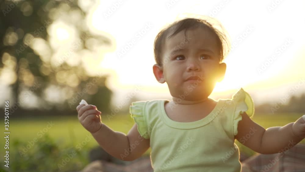 portrait close up of unhappy baby crying outdoor in the park portrait close up of unhappy baby crying outdoor in the park