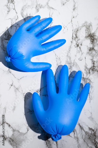 Flatlay with blue latex gloves on marble background