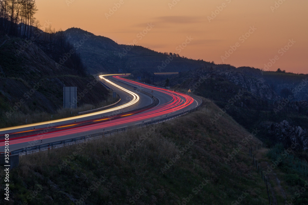 A 25 highway light trails left by cars at sunset , Viseu , Portugal