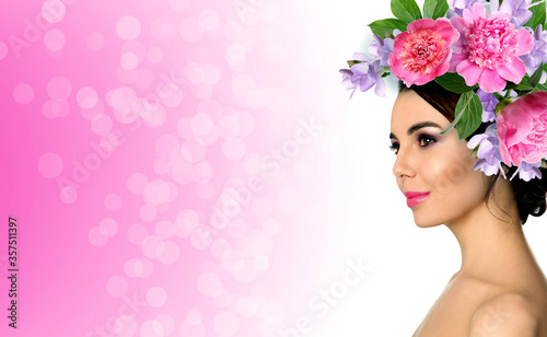 Fototapeta Naklejka Na Ścianę i Meble -  Young woman with beautiful makeup wearing flower wreath on pink background, space for text. Banner design