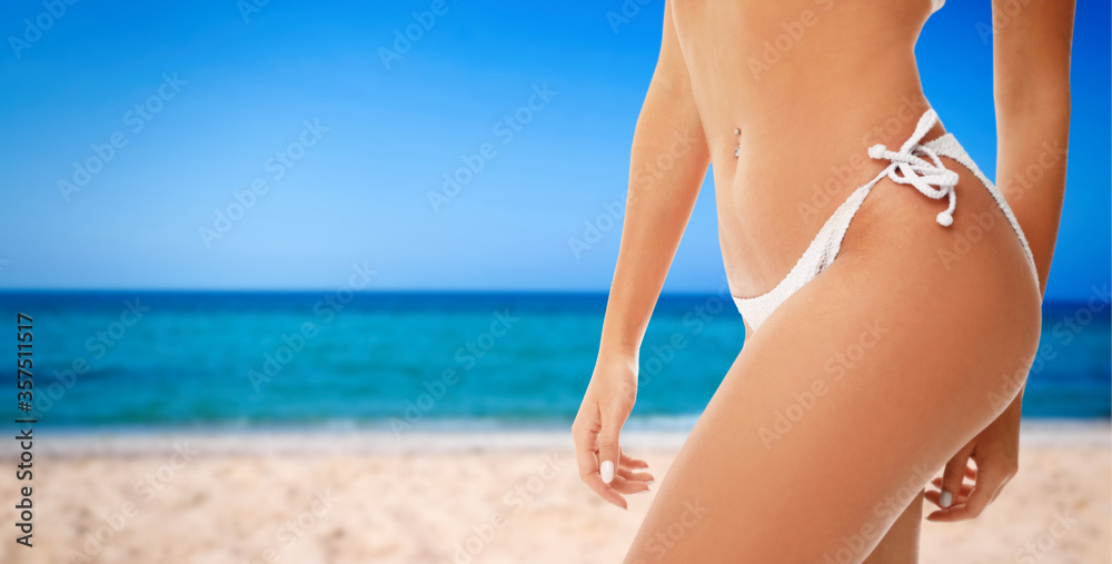 Sexy young woman wearing stylish bikini at beach on sunny day, closeup. Space for text