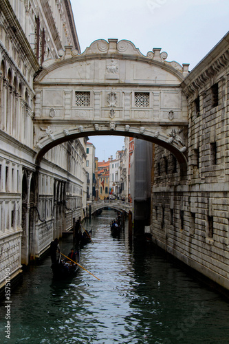 Gondola passing down the Bridge of Sighs (Ponte dei Sospiri) across the Palace Canal (Rio di Palazzo). Venice, Italy.