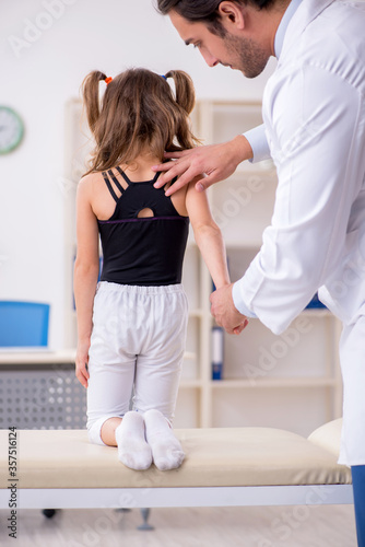 Small girl visiting young male doctor
