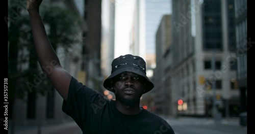 A black man raises his fist in solidarity for social and racial justice. Peaceful protest for equality and positive change.