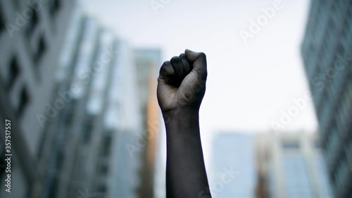 Raised black man's fist in protest. Social justice and peaceful protesting racial injustice. Shot in 4k.
