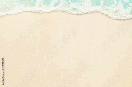 Ocean wave on the sand. Summer beach background with copy space