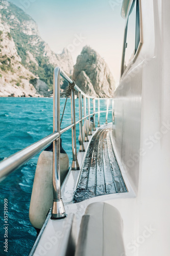 View from the yacht or the boat, sea blue water and mountains on the horizon. Yachting, sailing and voyage concept