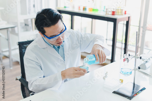 Asian scientists are preparing chemicals for testing and analysis in the laboratory. 