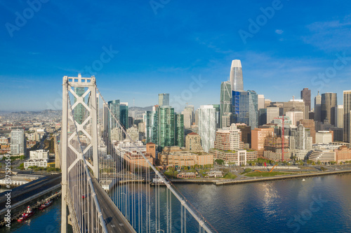 Aerial view of the San Francisco  California  skyline at sunrise. Ample copy space in blue sky. Bay bridge in foreground.
