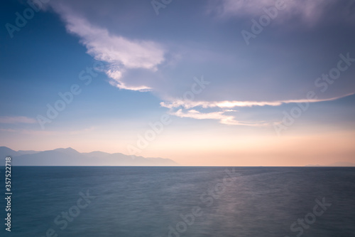sunset over the sea with big whit cloud on blue sky © pratan28