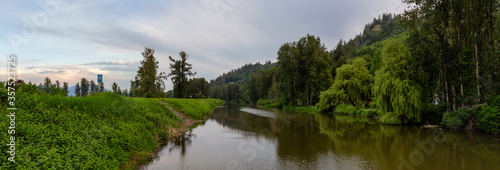 Beautiful Panoramic View of Sumas River during cloudy sunset. Taken in Abbotsford, East of Vancouver, British Columbia, Canada.