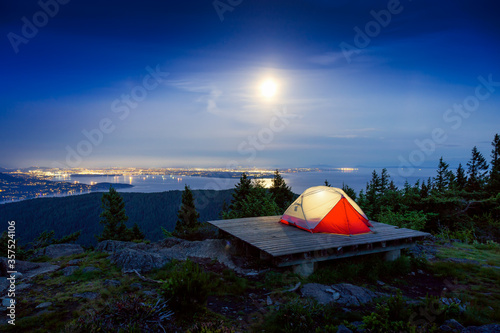 Camping Tent on top of a Mountain with Canadian Nature Landscape in the Background during colorful night after Sunset. Taken on Bowen Island, near Vancouver, British Columbia, Canada.