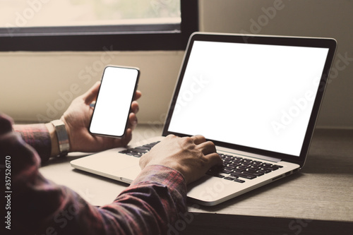 computer,cell phone mockup image.hand woman work using laptop texting mobile.blank screen with white background for advertising,contact business search information on desk in cafe.marketing,design