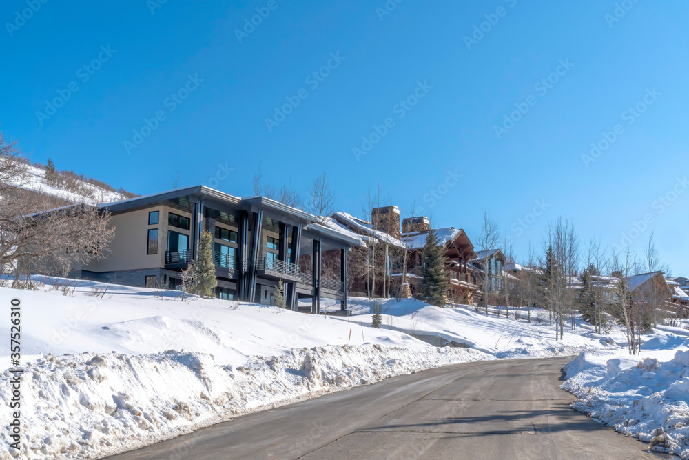 Road and homes on a luxury neighborhood in snowy Park City Utah in winter