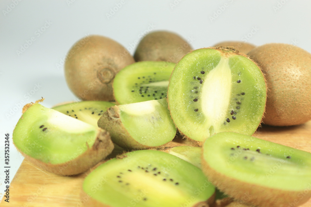 organic fresh juicy kiwi on wooden and white background. organic fresh juicy kiwi on wooden and white background.