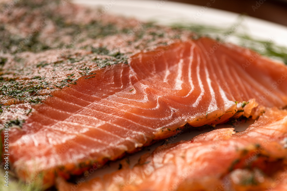 dried smoked salmon gravlax with dill on a white platter close up macro dried smoked salmon gravlax with dill on a white platter close up macro