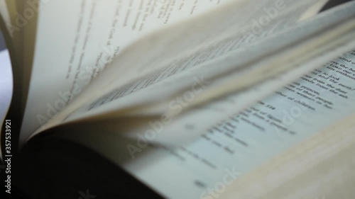 Slow motion of flipping through the pages of a book.