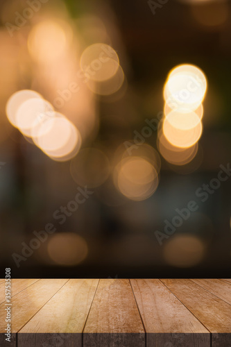 Wooden top table with bokeh light effect and blur restaurant on background, blur background.