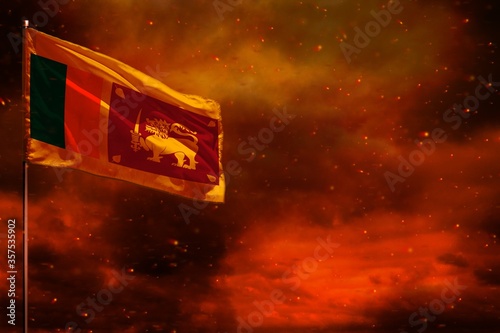 Fluttering Sri Lanka flag mockup with blank space for your text on crimson red sky with smoke pillars background. Troubles concept.