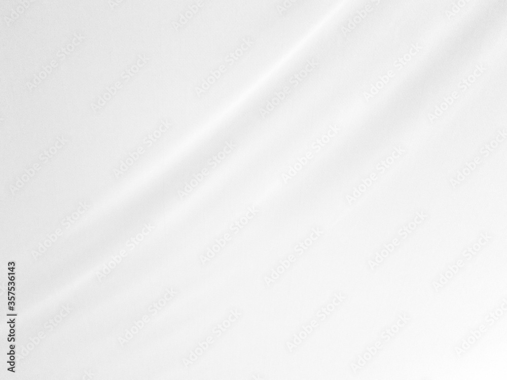 White silk satin background smooth texture background. The fabric is a light gray shining wave. White silk satin background smooth texture background. The fabric is a light gray shining wave.