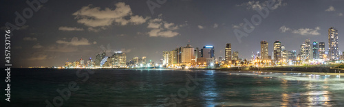 Panoramic view at night. Seascape and skyscrapers on background in Tel Aviv, Israel.