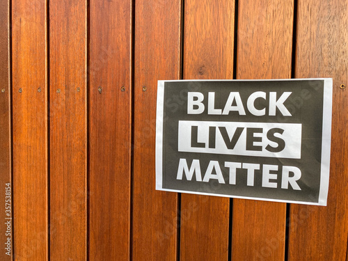 Black Lives Matter printed poster on wooden paneled wall