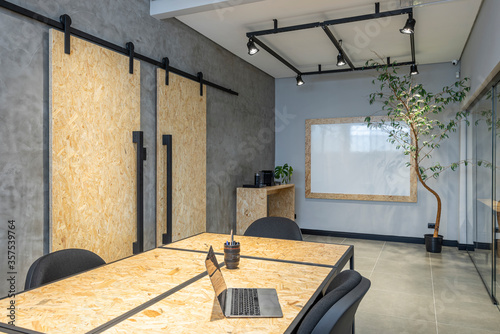 interior design of a office with notebook osb table and sliding doors