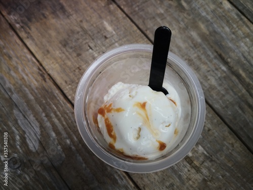 vanilla ice cream with cinnamon over wooden background
