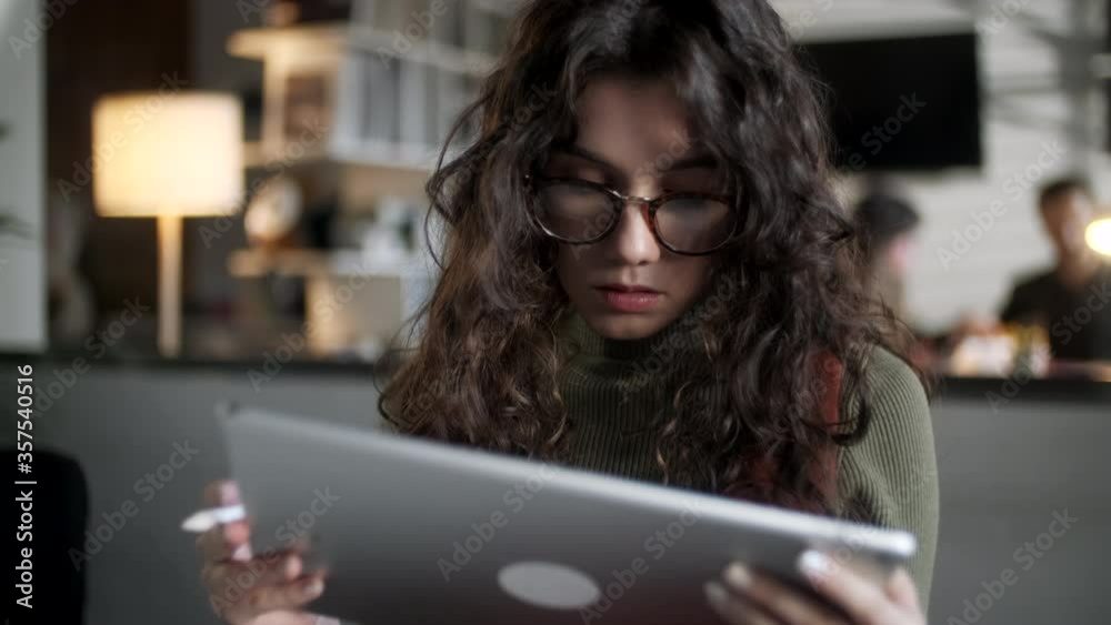 Beautiful Business Woman Using Tablet Computer Working Late In Office Browsing Information Looking At Data On Digital Touchscreen. Girl Draws With Pen On Tablet Beautiful Business Woman Using Tablet Computer Working Late In Office Browsing Information Looking At Data On Digital Touchscreen. Girl Draws With Pen On Tablet