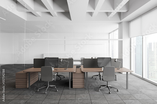 Grey and white open space office with meeting room