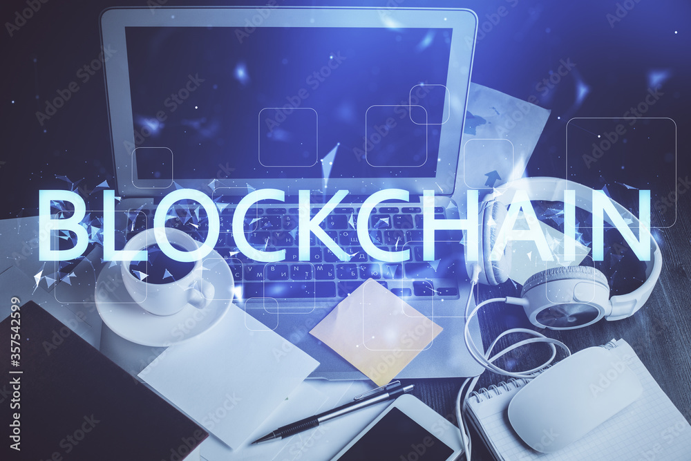 Multi exposure of blockchain and crypto economy theme hologram and table with computer background. Concept of bitcoin cryptocurrency.