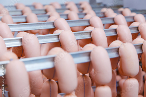Production of sausages. Sausages at the drying stage in the factory