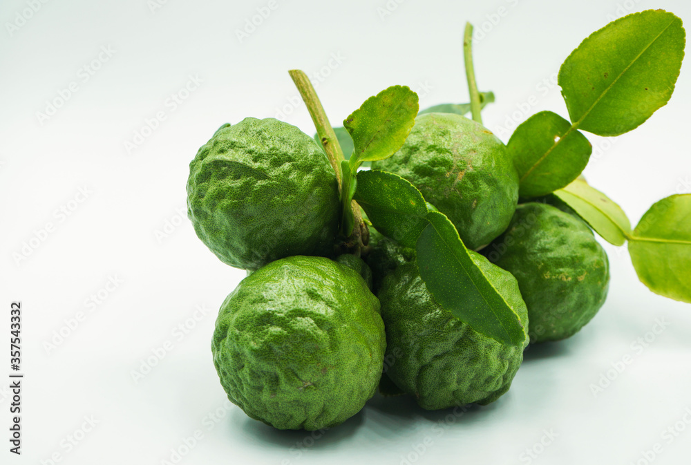Fresh bergamot fruit with leaf and cut in half of bergamot on white background Fresh bergamot fruit with leaf and cut in half of bergamot on white background