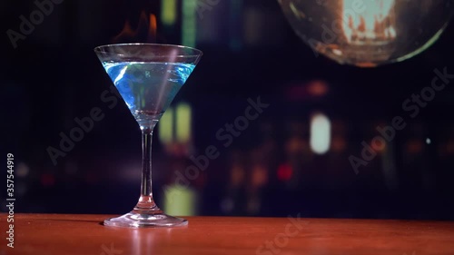 cocktail in a martini glass on bar background.