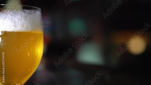 a glass of beer on bar background