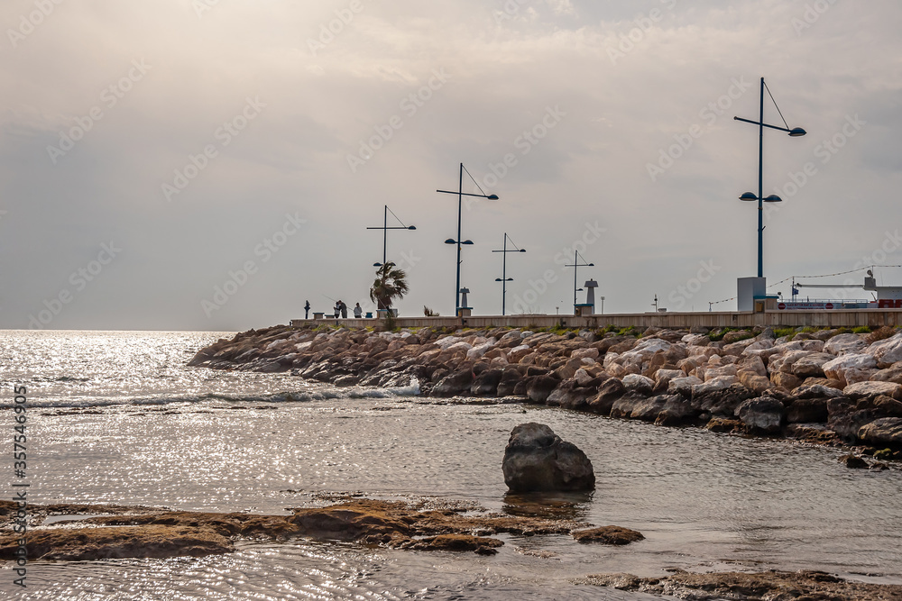 Embankment with lampposts on the background of sky and clouds