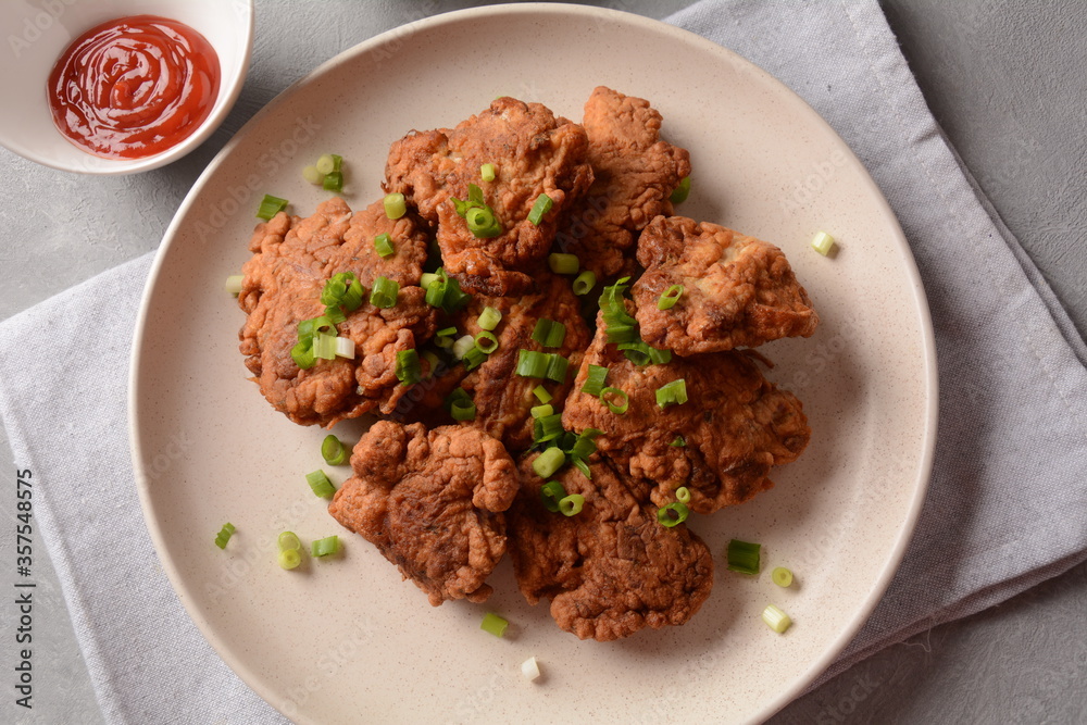 Fish in batter. Homemade Battered Fish Fry on the plate with fresh green onions. Fish in batter. Homemade Battered Fish Fry on the plate with fresh green onions.