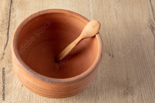 Wooden spoon on clay pot