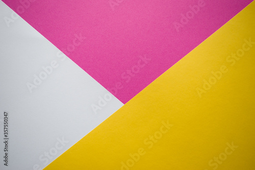White, pink and yellow background divided diagonally