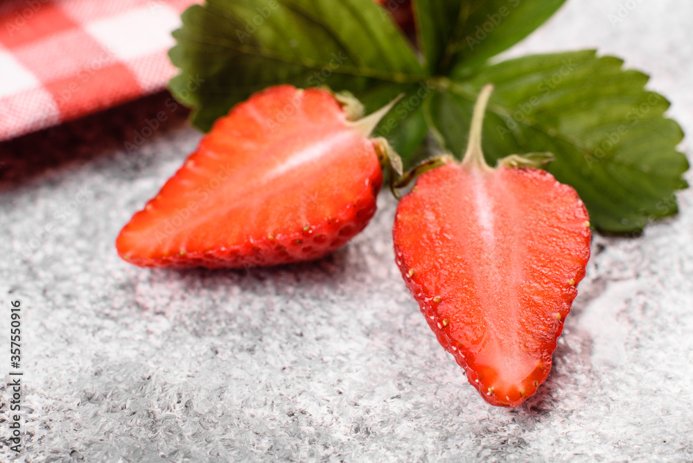 Beautiful juicy fresh strawberries on the concrete surface of the table
