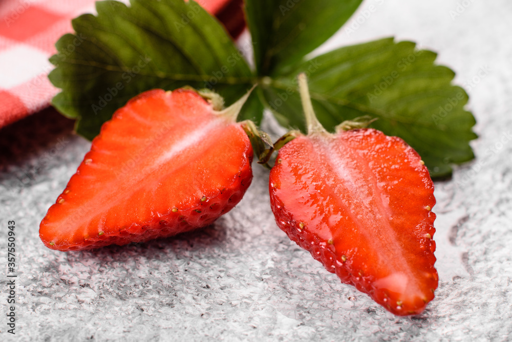 Beautiful juicy fresh strawberries on the concrete surface of the table Beautiful juicy fresh strawberries on the concrete surface of the table
